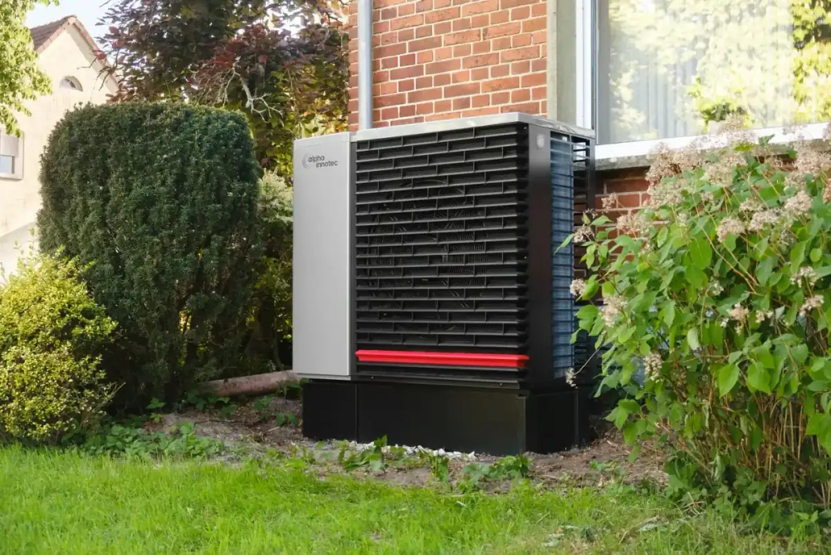 Heat pump outdoor unit installed beside a home